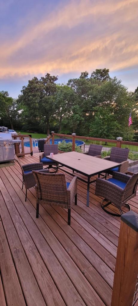 30847 Sun Ct, Burlington, WI 53105 - wooden deck with outdoor dining space and an outdoor pool