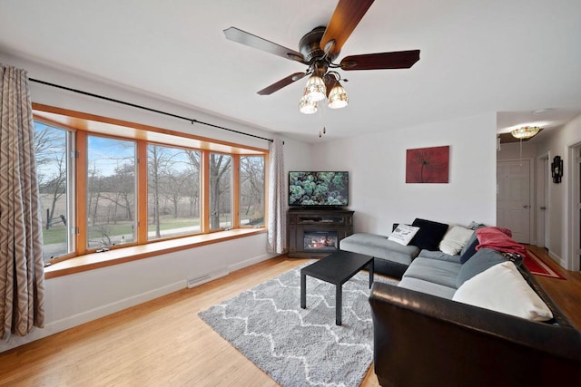 30847 Sun Ct, Burlington, WI 53105 - living room featuring visible vents, light wood-style flooring, and baseboards