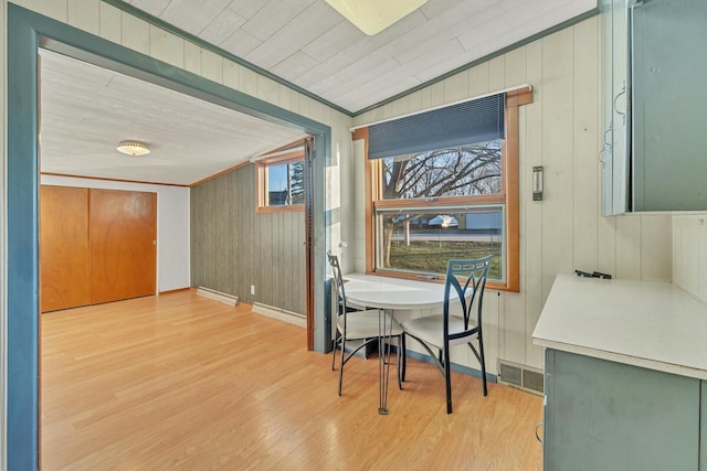 12606 234th Ave, Trevor, WI 53179 - dining room featuring crown molding, visible vents, wood finished floors, wooden walls, and baseboards