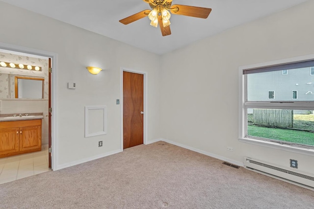 12606 234th Ave, Trevor, WI 53179 - unfurnished room featuring ceiling fan, light carpet, a sink, a baseboard radiator, and baseboards