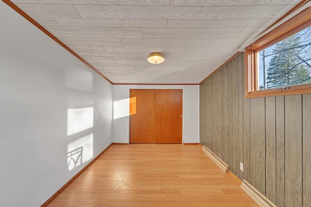 12606 234th Ave, Trevor, WI 53179 - hall featuring crown molding, light wood-type flooring, baseboard heating, wooden walls, and baseboards