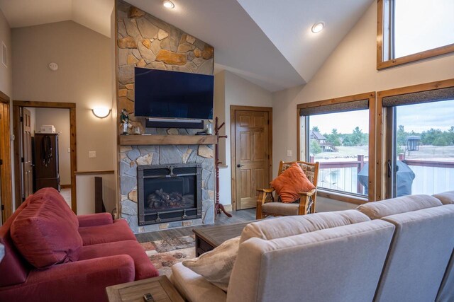 W5677 N Stone Gate Dr, New Lisbon, WI 53950 - living room featuring recessed lighting, high vaulted ceiling, wood finished floors, and a fireplace