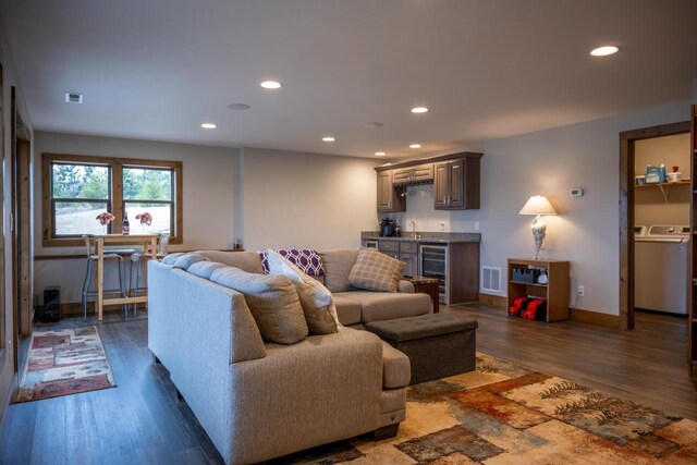 W5677 N Stone Gate Dr, New Lisbon, WI 53950 - living area with visible vents, indoor wet bar, wine cooler, recessed lighting, and washer / dryer