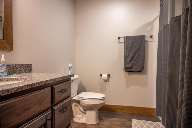 W5677 N Stone Gate Dr, New Lisbon, WI 53950 - bathroom featuring vanity, baseboards, curtained shower, toilet, and wood finished floors