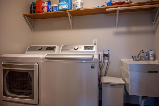 W5677 N Stone Gate Dr, New Lisbon, WI 53950 - washroom featuring independent washer and dryer, laundry area, and a sink