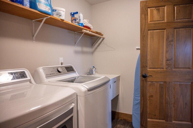 W5677 N Stone Gate Dr, New Lisbon, WI 53950 - clothes washing area with laundry area, separate washer and dryer, baseboards, and dark wood finished floors