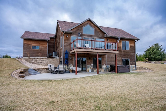 W5677 N Stone Gate Dr, New Lisbon, WI 53950 - back of property with a patio, central air condition unit, a wooden deck, a hot tub, and a yard
