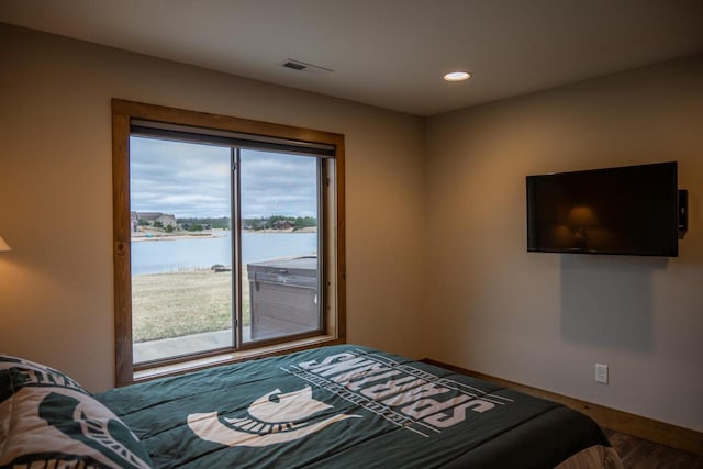 W5677 N Stone Gate Dr, New Lisbon, WI 53950 - bedroom featuring wood finished floors, multiple windows, visible vents, and recessed lighting