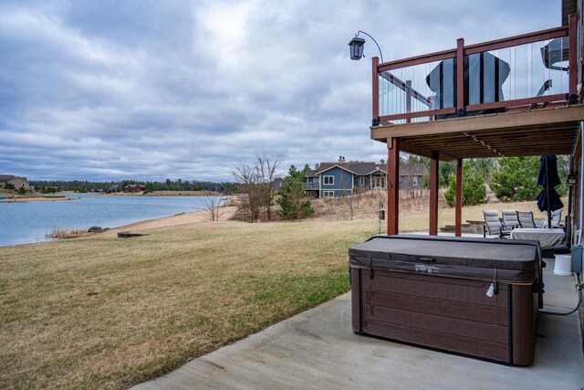 W5677 N Stone Gate Dr, New Lisbon, WI 53950 - view of yard featuring a deck with water view, a hot tub, and a patio