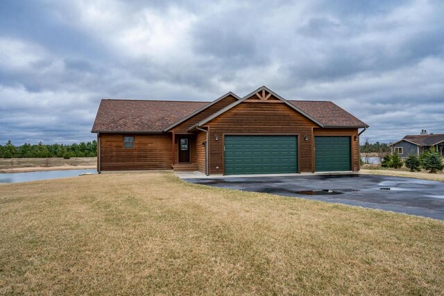 W5677 N Stone Gate Dr, New Lisbon, WI 53950 - view of front of house with driveway, roof with shingles, a front yard, and a garage