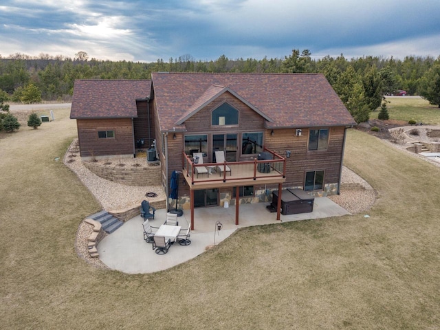 W5677 N Stone Gate Dr, New Lisbon, WI 53950 - rear view of property featuring a patio area, a yard, a hot tub, and a deck