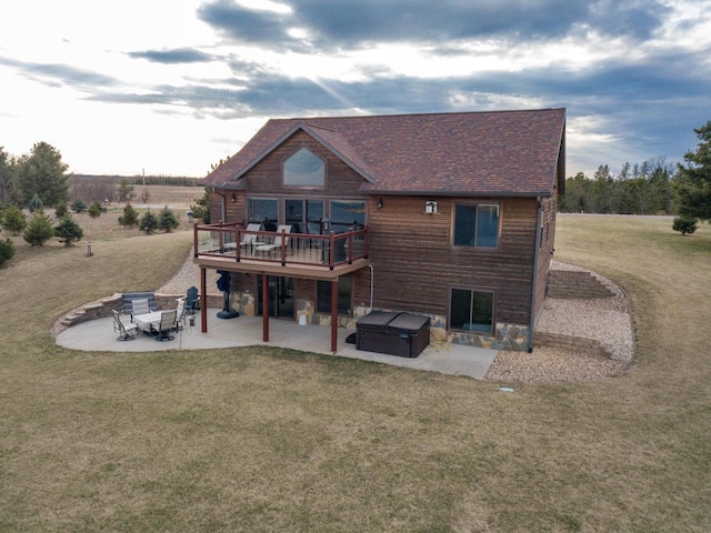 W5677 N Stone Gate Dr, New Lisbon, WI 53950 - back of house with a shingled roof, a yard, a wooden deck, a patio, and a hot tub