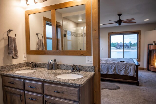 W5677 N Stone Gate Dr, New Lisbon, WI 53950 - ensuite bathroom featuring a sink, double vanity, connected bathroom, and a shower with door