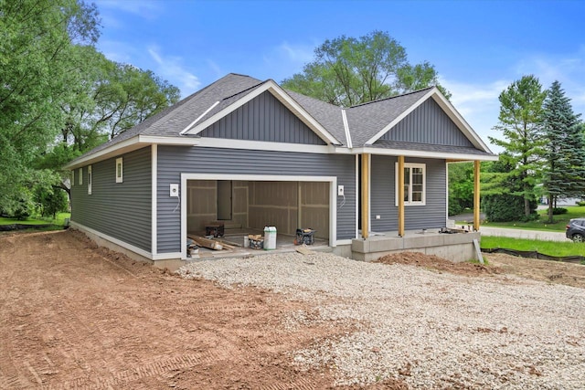 LT2 Steeple View Rd, West Bend, WI 53095 - view of front of house with an attached garage, a porch, roof with shingles, and board and batten siding