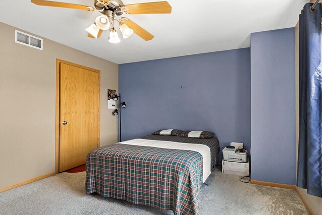 bedroom with baseboards, ceiling fan, carpet flooring, and visible vents
