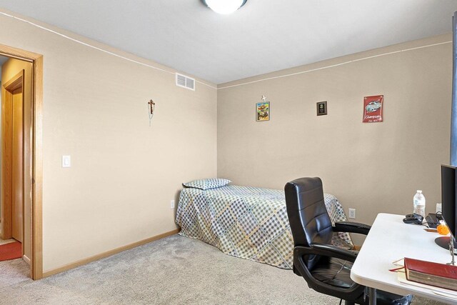 carpeted bedroom featuring baseboards and visible vents