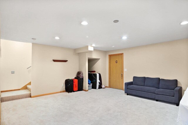 living room featuring carpet, recessed lighting, and stairs