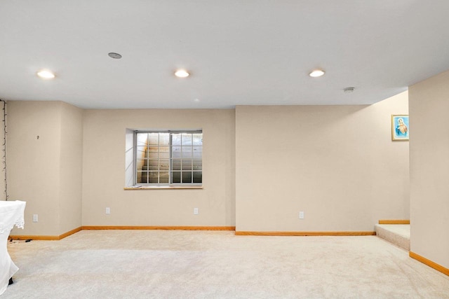 below grade area with carpet floors, recessed lighting, and baseboards