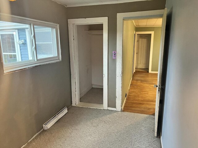 5169 Kratz Rd, Omro, WI 54963 - unfurnished bedroom featuring a closet, ornamental molding, carpet floors, attic access, and a baseboard radiator