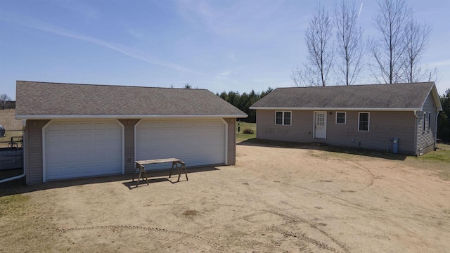 N302 24th Ave, Neshkoro, WI 54960 - view of front of house with a garage, an outbuilding, and roof with shingles
