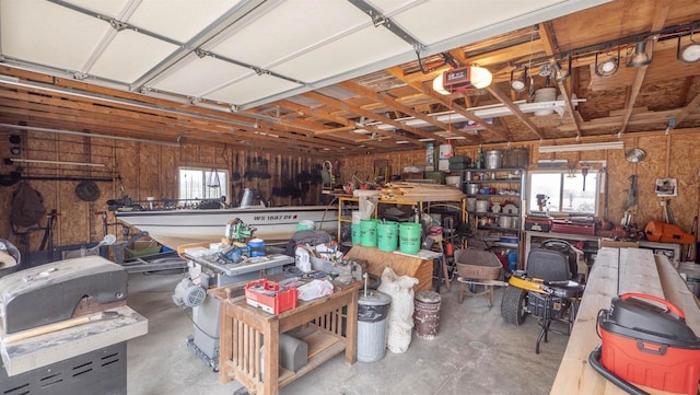 N302 24th Ave, Neshkoro, WI 54960 - garage with a workshop area, a garage door opener, and wooden walls