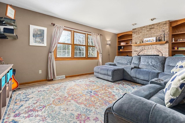 101 Brookview Pl, Combined Locks, WI 54113 - living area featuring wood finished floors, a brick fireplace, and built in features