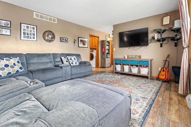 101 Brookview Pl, Combined Locks, WI 54113 - living room featuring washer / clothes dryer and wood finished floors