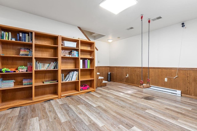 101 Brookview Pl, Combined Locks, WI 54113 - spare room with wood finished floors, wainscoting, a baseboard radiator, and wood walls