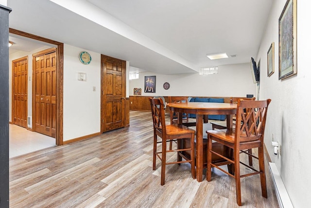 101 Brookview Pl, Combined Locks, WI 54113 - dining area with light wood finished floors and a baseboard radiator