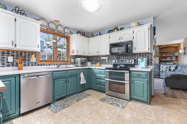 101 Brookview Pl, Combined Locks, WI 54113 - kitchen with stainless steel appliances, white cabinetry, backsplash, and light countertops