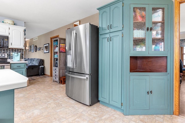 101 Brookview Pl, Combined Locks, WI 54113 - kitchen featuring appliances with stainless steel finishes, blue cabinetry, tasteful backsplash, and light countertops