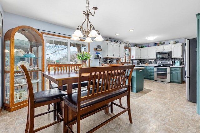 101 Brookview Pl, Combined Locks, WI 54113 - dining area with healthy amount of natural light, a chandelier, recessed lighting, and light stone finish floors