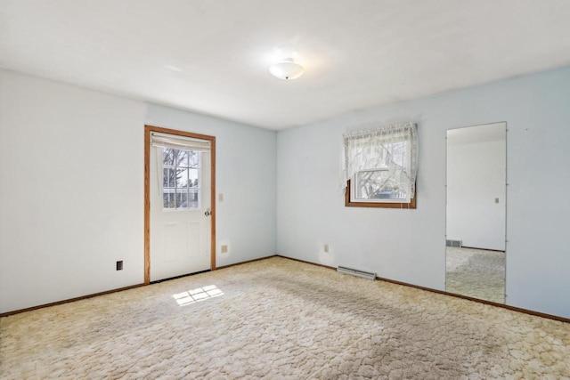 spare room with baseboards, visible vents, and carpet flooring