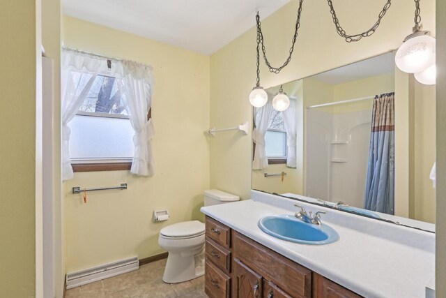 full bath featuring a baseboard heating unit, toilet, vanity, and plenty of natural light