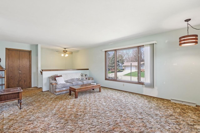living room featuring carpet, visible vents, and a ceiling fan