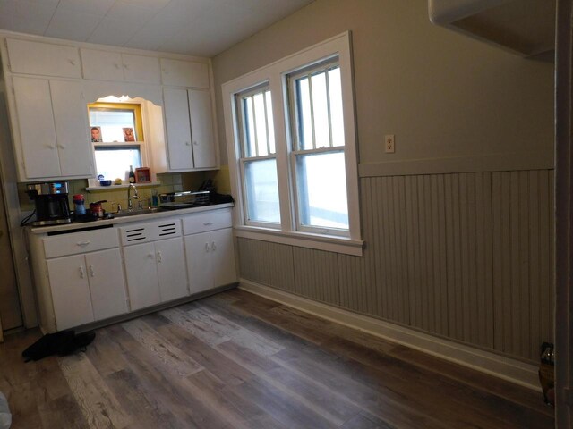 4058 N 7th St, Milwaukee, WI 53209 - kitchen featuring white cabinets, a sink, and wood finished floors