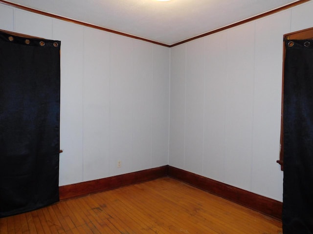 4058 N 7th St, Milwaukee, WI 53209 - unfurnished room with a decorative wall, hardwood / wood-style flooring, and ornamental molding