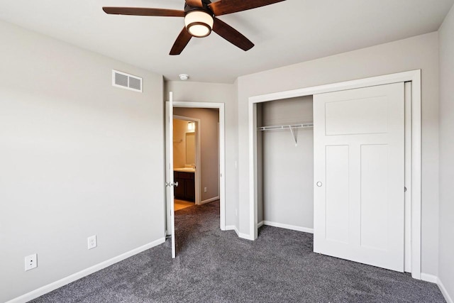 1059 Okeeffe Ave, Sun Prairie, WI 53590 - unfurnished bedroom featuring dark colored carpet, baseboards, a closet, and ceiling fan