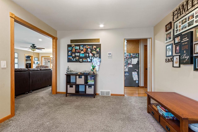 hallway with baseboards, visible vents, recessed lighting, and carpet flooring