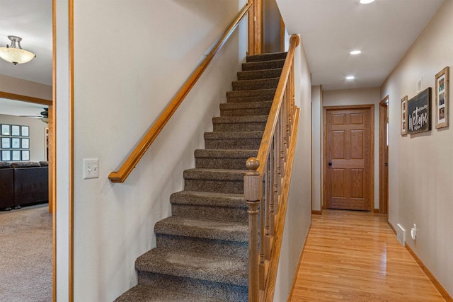 stairs featuring recessed lighting, wood finished floors, baseboards, and ceiling fan