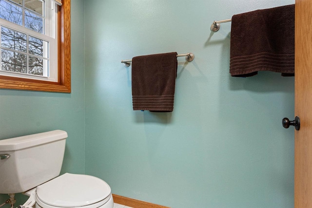 bathroom with toilet and baseboards