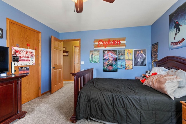 carpeted bedroom with baseboards and a ceiling fan