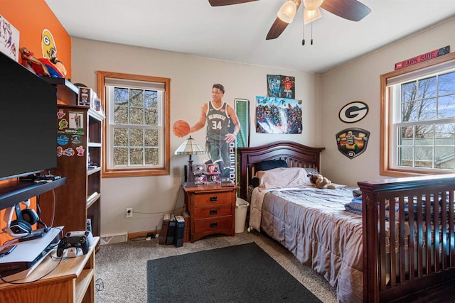 bedroom with baseboards, a ceiling fan, carpet flooring, and multiple windows