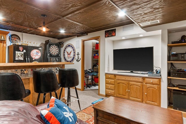 interior space with baseboards, visible vents, a bar, and light colored carpet
