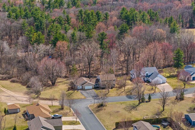 drone / aerial view featuring a view of trees and a residential view