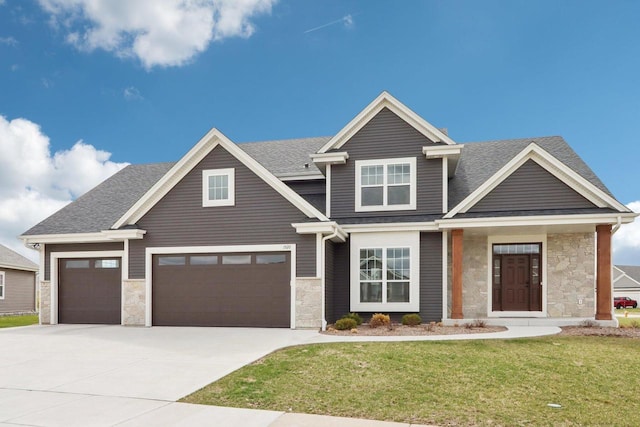 1520 Fay Ln, Oconomowoc, WI 53066 - craftsman inspired home with roof with shingles, stone siding, a front yard, and concrete driveway