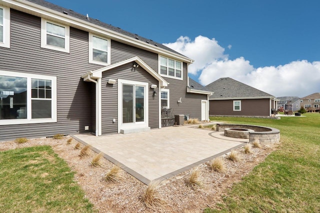 1520 Fay Ln, Oconomowoc, WI 53066 - rear view of house featuring a patio area, a lawn, and an outdoor fire pit