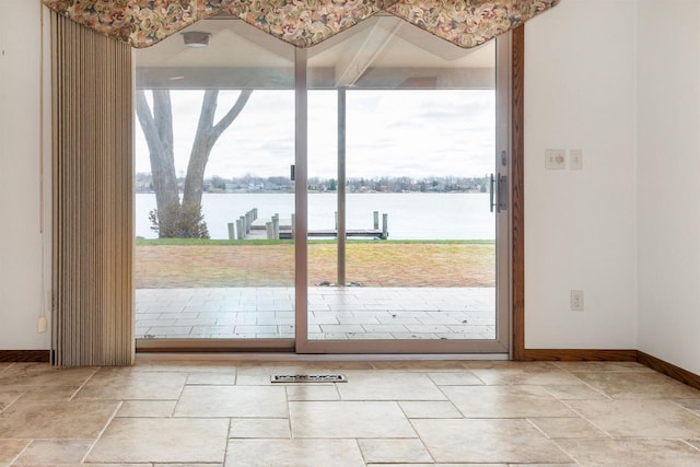 2151 Sunrise Dr, Appleton, WI 54914 - entryway with stone tile flooring, baseboards, a wealth of natural light, and a water view