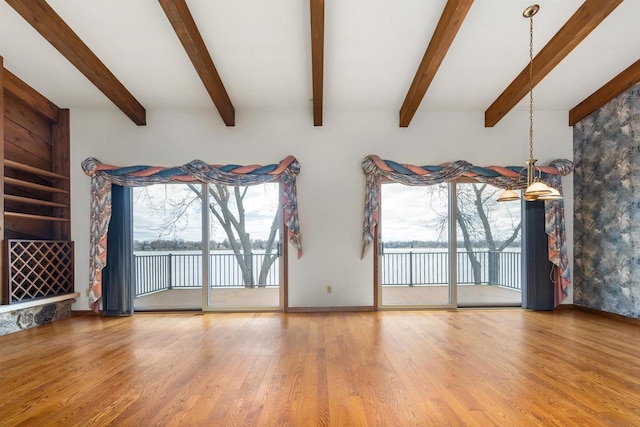 2151 Sunrise Dr, Appleton, WI 54914 - unfurnished living room with baseboards, wood finished floors, a wealth of natural light, and a water view