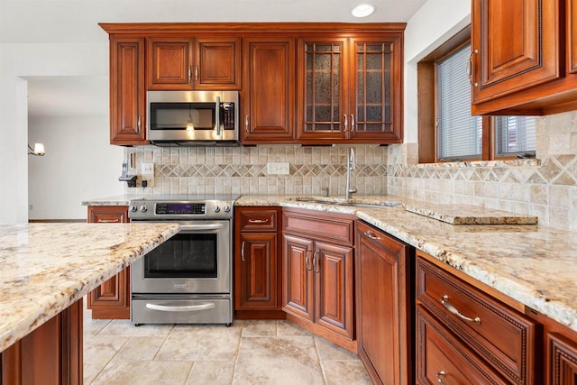 2151 Sunrise Dr, Appleton, WI 54914 - kitchen with tasteful backsplash, light stone countertops, appliances with stainless steel finishes, and a sink